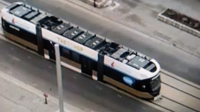 <p><strong>Once on the tracks, a transit crew raised the car's&nbsp;pantograph to an overhead wire, powering up the car, then&nbsp;moved it slowly to the system's terminal. Streetcars should be operating this fall.</strong></p>