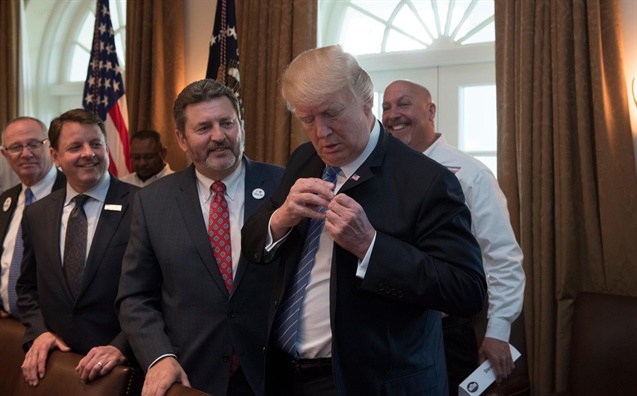 <p><strong>ATA Chairman Kevin Burch, left gave President Trump an "I (heart) Trucks" pin.</strong><em> Photo: ATA</em></p>