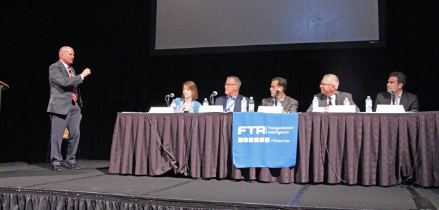 <p><strong>A panel discussion at the FTR Conference tackles the Amazon effect, with FTR's Eric Starks (left) moderating.</strong> <em>Photo: Evan Lockridge</em></p>