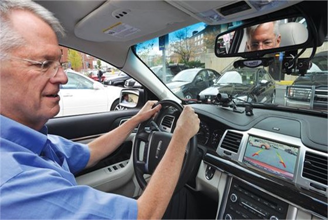 A driver uses a parking assist system to parallel park. Photo courtesy of IIHS.
